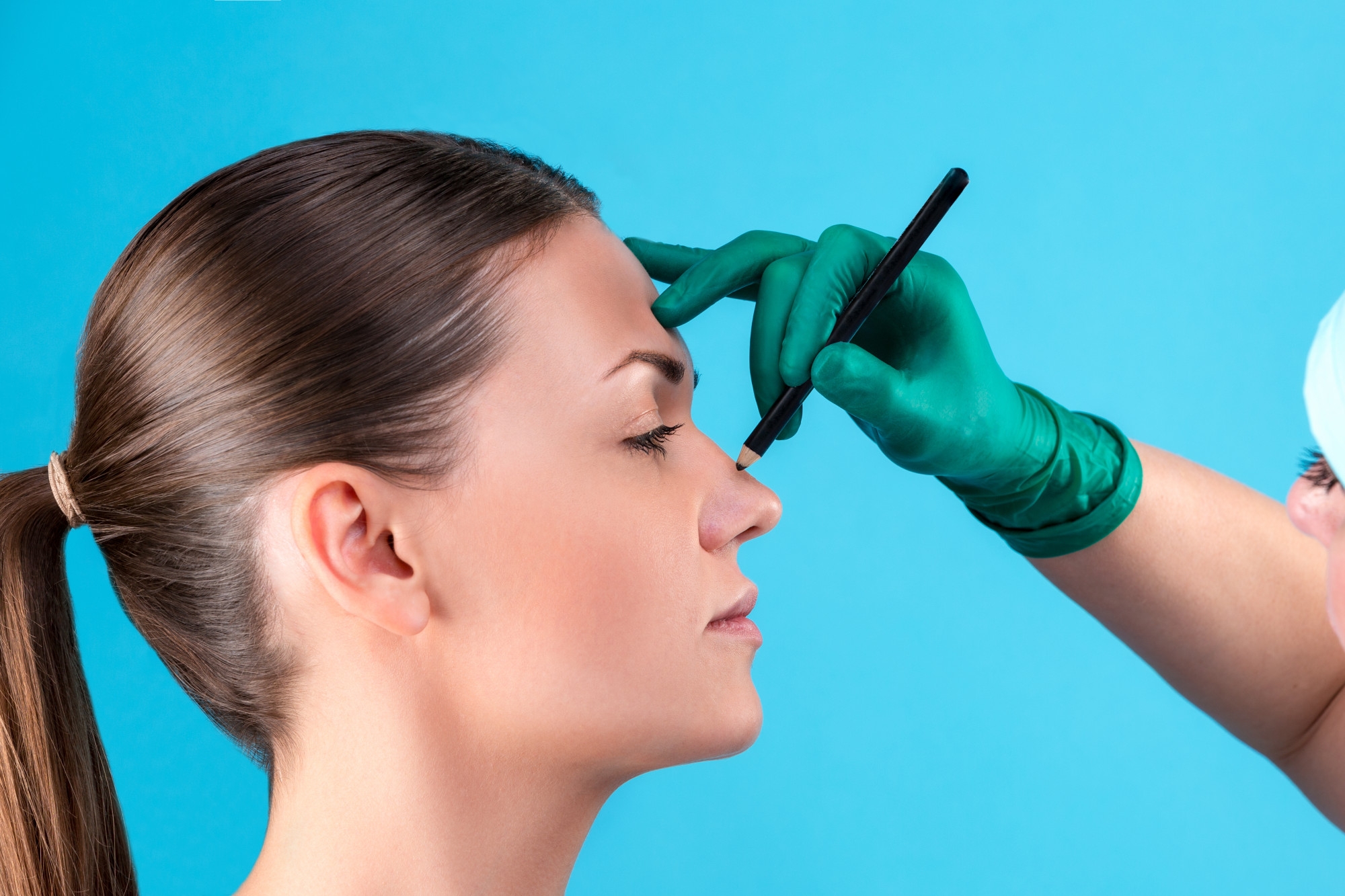 cosmetic-surgeon-examining-female-client-office-doctor-draws-lines-with-marker-eyelid-before-plastic-surgery-blepharoplasty-surgeon-beautician-hands-touching-woman-face-rhinoplasty