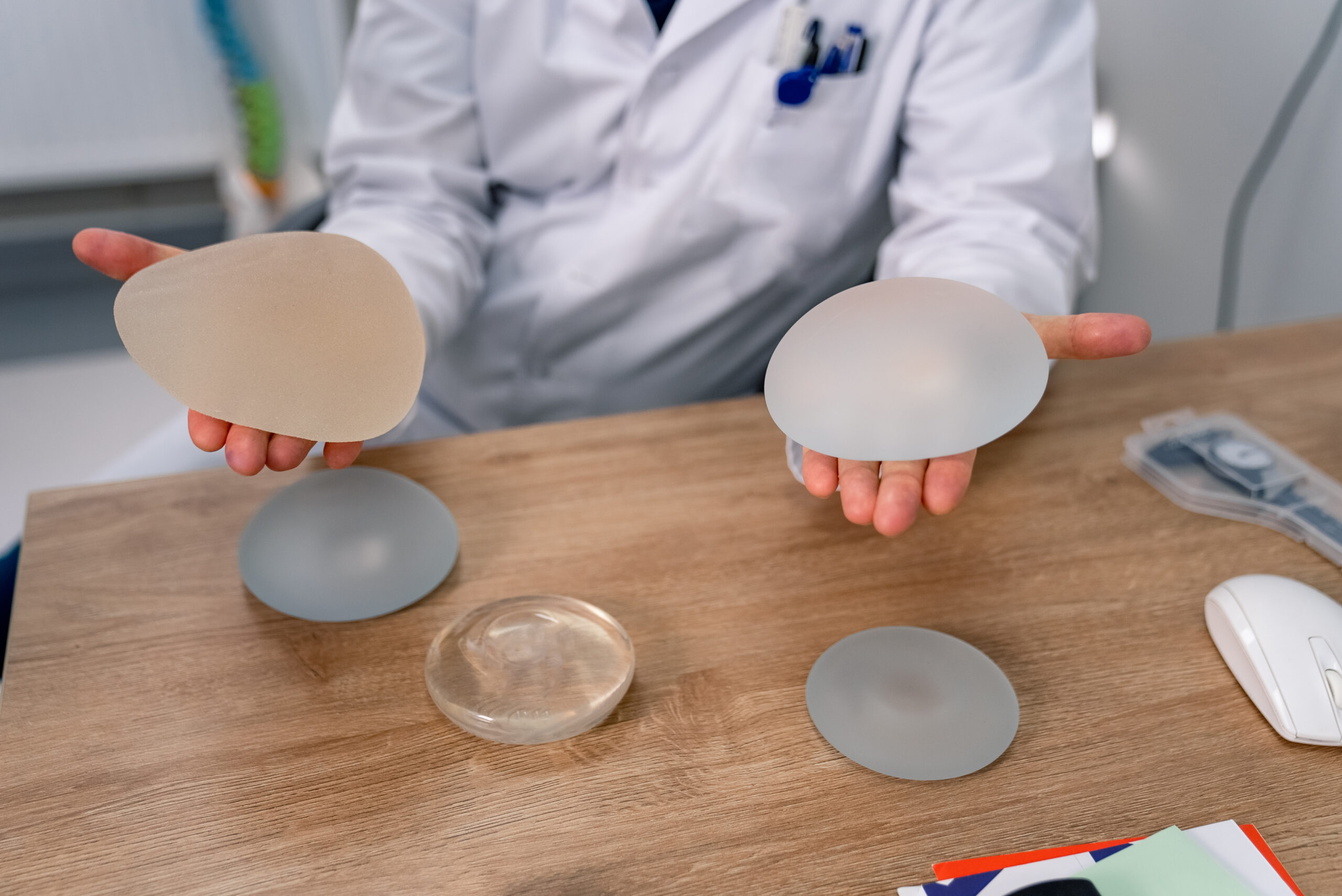Doctor holding implants in his hands. Medical silicon implants in doctor hands.